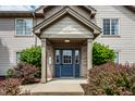Charming condo entrance featuring a blue door, well-kept landscaping, and clear unit number at 246 Legends Creek Way # Apt 207, Indianapolis, IN 46229