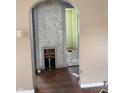 Arched doorway reveals interior with hardwood floors and damaged walls ready for renovation at 2742 Allen Ave, Indianapolis, IN 46203