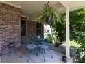Close up view of a lovely front porch with outdoor furniture and hanging plants, creating a serene ambiance at 2756 Bluebell E Ct, Columbus, IN 47201