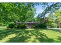 Charming brick ranch home with well-maintained lawn and mature trees at 2808 Woodside Dr, Plainfield, IN 46168