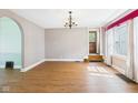 Inviting living room with hardwood floors, arched doorways, and natural light from the window at 328 Marine Dr, Anderson, IN 46016