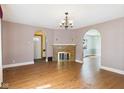 Spacious living room with hardwood floors, a brick fireplace, and arched doorways leading to other rooms at 328 Marine Dr, Anderson, IN 46016