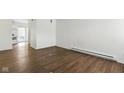 An open-concept living room featuring hardwood floors and a doorway leading into the kitchen at 3343 Ashley Ln, Indianapolis, IN 46224