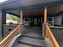 Inviting front porch with steps leading up to a covered entrance, stylish railings, and modern lighting at 3962 Graceland Ave, Indianapolis, IN 46208