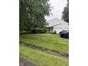 View of the home from the yard, highlighting the two-car garage at 4404 London Ct, Indianapolis, IN 46254