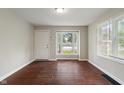 Bright living room featuring hardwood floors, a large window, and neutral paint, ready for personalization at 4517 E 16Th St, Indianapolis, IN 46201