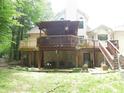 Multi-level deck with outdoor seating, surrounded by trees, and offering a peaceful backyard retreat at 4521 Tulip N Dr, Martinsville, IN 46151