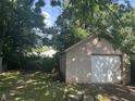 Exterior view of the detached garage featuring concrete block and white garage door at 4723 Crittenden Ave, Indianapolis, IN 46205