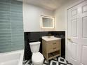Contemporary bathroom featuring a modern vanity, decorative tile, and updated fixtures at 5115 Primrose Ave, Indianapolis, IN 46205