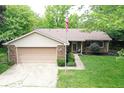 Beautifully maintained home boasts a brick and siding exterior, attached garage, and lush green yard at 610 Front Royal Dr, Indianapolis, IN 46227