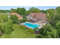Aerial view of backyard featuring a large in-ground pool, patio area, and lush landscaping at 625 La Placita St, Greenwood, IN 46143