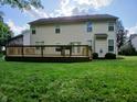 Backyard with a spacious wooden deck and lush green lawn, perfect for outdoor entertaining and relaxation at 6483 Timber Walk Dr, Indianapolis, IN 46236