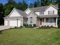 Charming two-story home with brick and siding, attached garage, and a well-manicured lawn at 6483 Timber Walk Dr, Indianapolis, IN 46236
