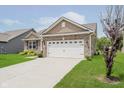 Charming single-Gathering home featuring a well manicured lawn and attached two car garage at 6644 Aberdeen Dr, McCordsville, IN 46055