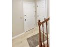 Inviting entryway with staircase featuring wood railing and white doors at 6839 Antelope Dr, Indianapolis, IN 46278