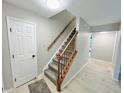 Bright foyer area showcasing staircase with wood railing and access to main floor at 6839 Antelope Dr, Indianapolis, IN 46278