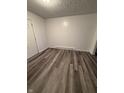 Cozy bedroom features wood laminate flooring, fresh white walls, and neutral trim at 8434 Meadowlark Dr, Indianapolis, IN 46226