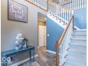 Inviting foyer with staircase, stylish decor, and warm, neutral color palette creating a welcoming ambiance at 1035 White Oak Dr, Plainfield, IN 46168