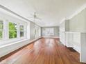 Spacious living room with hardwood floors, large windows, and ceiling fan at 1201 Arrow Ave, Anderson, IN 46016