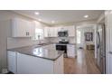 Modern kitchen with white cabinets, stainless steel appliances, granite countertops, and subway tile backsplash at 13074 Lansdowne Dr, Fishers, IN 46038