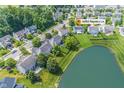 Scenic aerial shot of a neighborhood with a serene pond, highlighting the community's lush greenery and well-spaced homes at 14052 Rayners Ln, Fishers, IN 46037