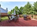 Relaxing outdoor living space featuring a spacious deck, patio furniture, barbecue grill, and backyard at 14082 Brazos Dr, Carmel, IN 46033
