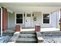 Close up front porch view with white door and brick columns at 1430 W 14Th St, Anderson, IN 46016