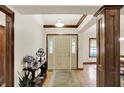 Inviting entryway showcasing hardwood floors, decorative wood trim, and a stylish console table at 1456 Bent Tree Pl, Greenwood, IN 46143