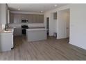 Spacious kitchen with stainless steel appliances, gray cabinets, and a center island at 17110 Cowbell Dr, Noblesville, IN 46060