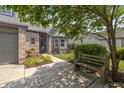 Inviting home exterior with a cozy bench, brick accents, and colorful garden bed at 19522 Diamond Way, Noblesville, IN 46062