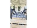 Inviting front porch featuring stylish chairs, a blue patterned rug, and a welcoming entrance with a wreath at 249 N Mill St, Plainfield, IN 46168