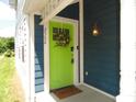 Inviting entryway features a bright green door with wreath and modern house numbers at 2502 N Harding St, Indianapolis, IN 46208