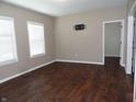 Spacious living room with hardwood floors, big windows, and neutral paint at 2502 N Harding St, Indianapolis, IN 46208