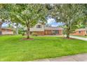 Traditional two-story home with brick and siding, mature trees, and a welcoming front porch at 2823 Tulip Dr, Indianapolis, IN 46227