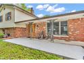 Inviting covered porch with rocking chairs, decorative columns, and brick facade offers a cozy outdoor space at 2823 Tulip Dr, Indianapolis, IN 46227
