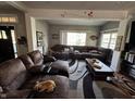 Spacious living room with a large sectional sofa, a patterned rug, and natural light at 3054 Ruckle St, Indianapolis, IN 46205