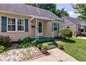 Charming home's front porch with green trim, white awning, and landscaped garden beds at 315 W 43Rd St, Indianapolis, IN 46208