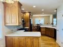The kitchen boasts oak cabinetry, white countertops, and seamlessly connects to the dining area at 3418 S Rosewind Dr, New Palestine, IN 46163