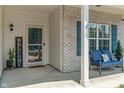 Close-up of a quaint front porch, featuring a welcoming bench, decorative shutters, and a stylish 'Welcome' sign at 3420 Stoddard Pl, Indianapolis, IN 46217
