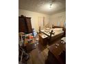 Bedroom featuring hardwood floors, an antique bed frame and an armoire at 3709 N Layman Ave, Indianapolis, IN 46218