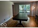 Dining area with hardwood floors, a large table, and a bright window at 3815 Briar Rdg, Monrovia, IN 46157