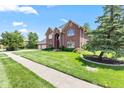 Beautiful red brick home with a manicured lawn and mature trees at 4465 W Woodbridge Ln, New Palestine, IN 46163