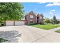 Spacious brick home boasting a three-car garage and large driveway at 4465 W Woodbridge Ln, New Palestine, IN 46163