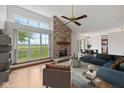 Bright living room with stone fireplace, large windows, and a view of the scenic outdoors at 4609 Framington Ct, Indianapolis, IN 46254