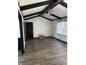 Bright living room with modern wood floors, black trim, ceiling fan, and a front door at 5453 David St, Indianapolis, IN 46226