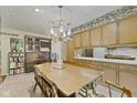 Spacious dining area featuring a vintage chandelier and ample storage cabinets at 618 Mellowood Dr, Indianapolis, IN 46217