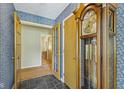 Charming foyer with slate floors, grandfather clock, and multiple doorways at 618 Mellowood Dr, Indianapolis, IN 46217