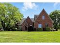 Charming brick home featuring well-maintained lawn and mature trees, offering a serene outdoor setting at 6183 Whitetail Run, Greenwood, IN 46143