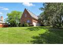 Spacious backyard showcasing lush lawn, mature trees, and attached garage, perfect for outdoor activities at 6183 Whitetail Run, Greenwood, IN 46143