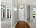 Elegant foyer with hardwood floors and arched doorway, creating a grand entrance to the home at 6183 Whitetail Run, Greenwood, IN 46143